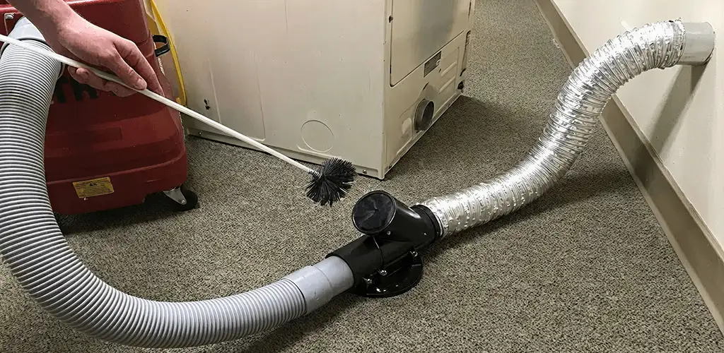 Dryer vent cleaning service removing lint from a dryer duct connection in Bakersfield, CA