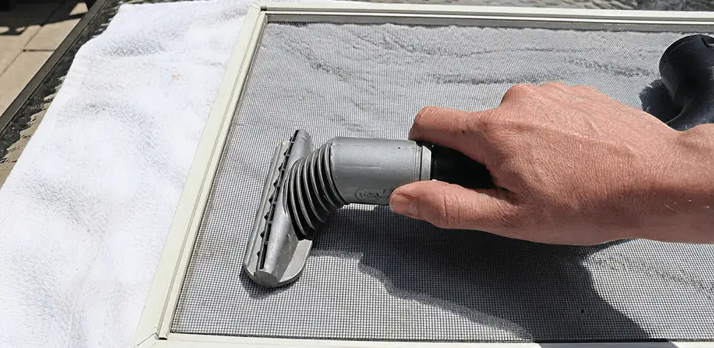 Window screen repair cleaning and fixing a damaged screen mesh in Bakersfield, CA