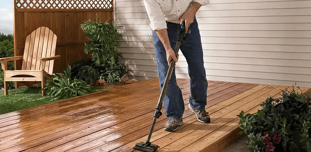 Deck staining service applying stain to a backyard wood deck in Bakersfield, CA
